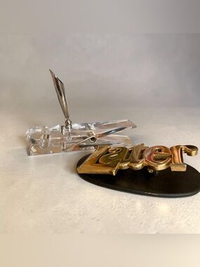 Two vintage desk accessories, brass paperweight, and acrylic clothes pin